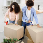 People moving boxes into a new home