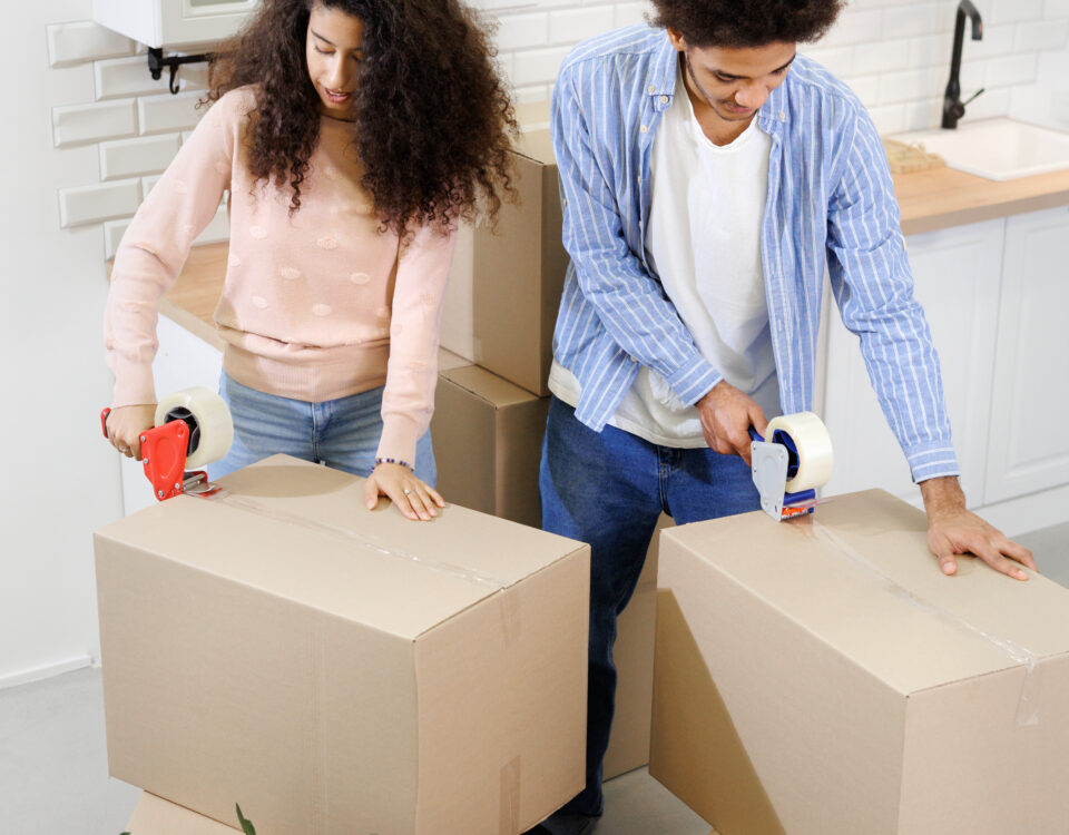 People moving boxes into a new home